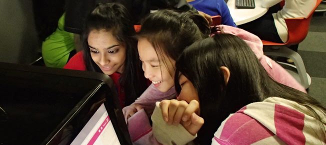 Federal Funding For STEM Empowers A New Generation Of Canadians 3 young girls laughing together while staring at a computer screen