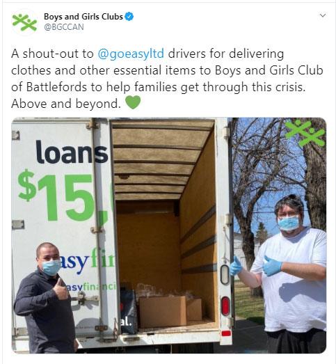 Two goeasy drivers wearing masks give a thumbs up in front of an open delivery truck filled with essential items for the Boys and Girls Club of Battlefords.