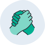 A young girl smiling at a table next to a boy and girl playing with sock puppets.