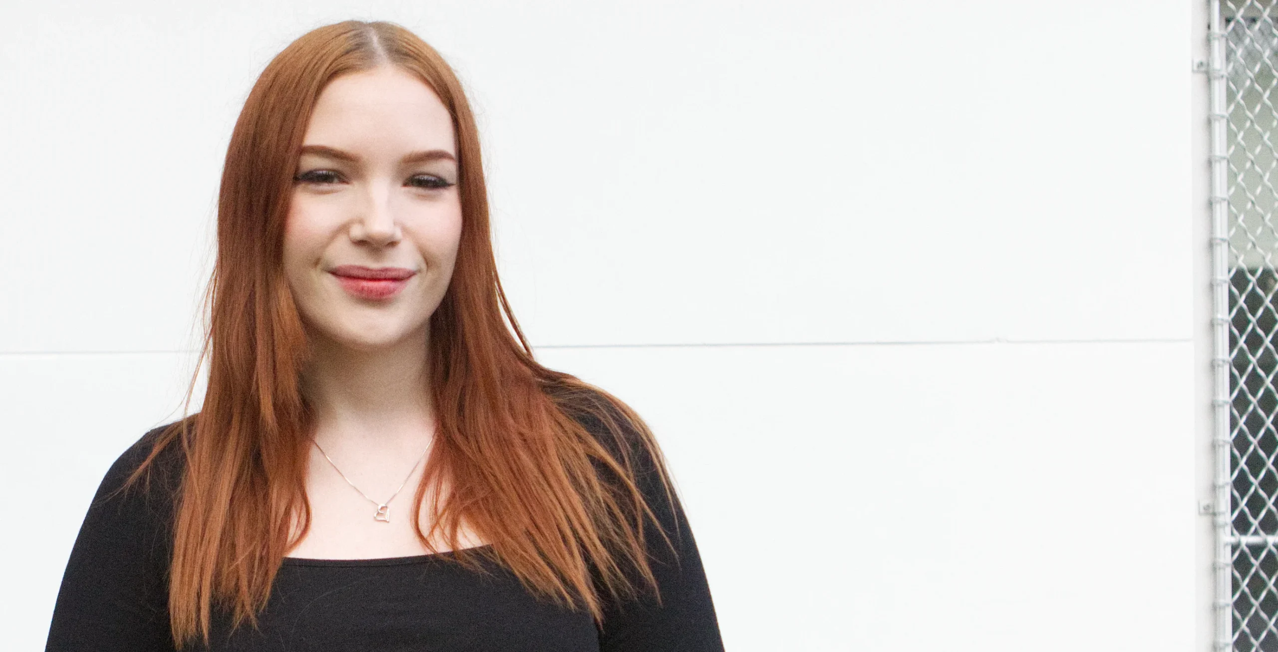 Yael smiling in a portrait photo for The Club Experience story.