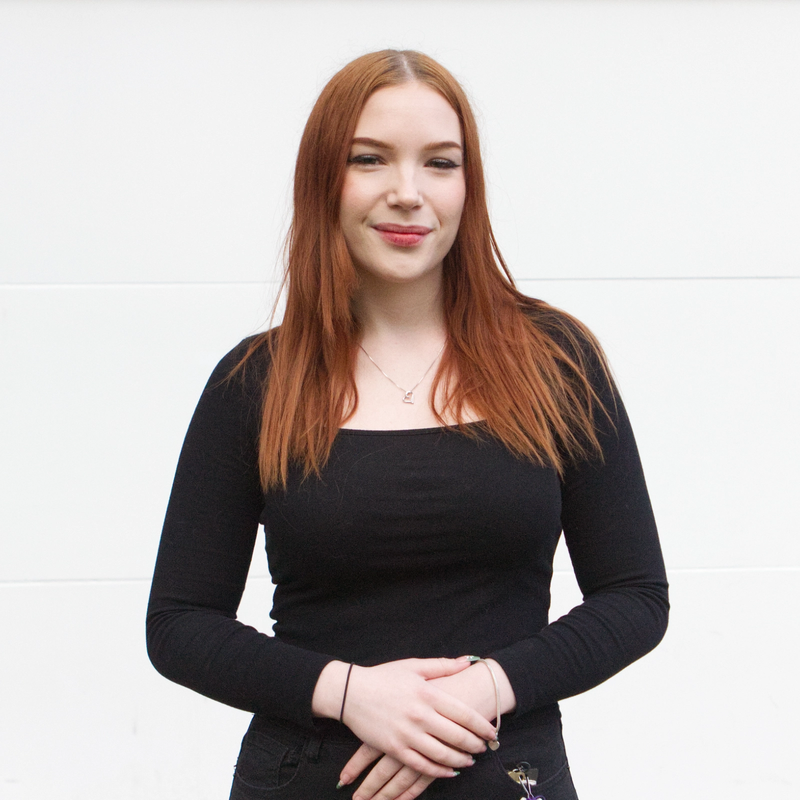 Yael smiling in a portrait photo for The Club Experience story.