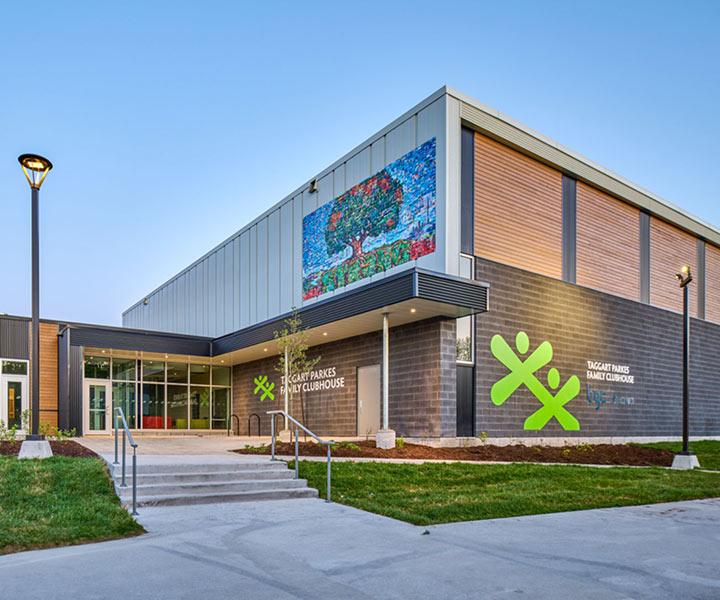 A modern community building features the "Taggart Parkes Family Clubhouse" sign alongside a large BGC logo and an intricate tree mural.