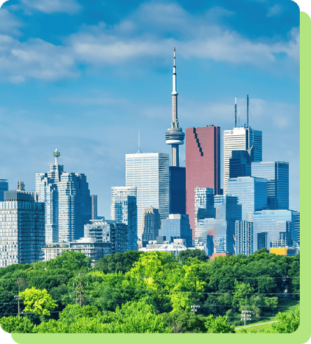 contact-national A vibrant view of the Toronto skyline, featuring the CN Tower and various skyscrapers rising behind a lush green forest under a blue sky.