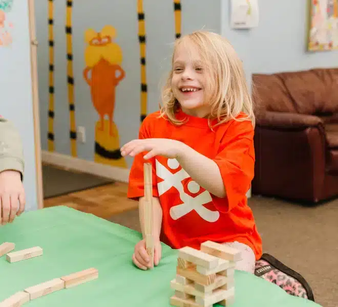 A child playing a block-stacking game during a Club activity