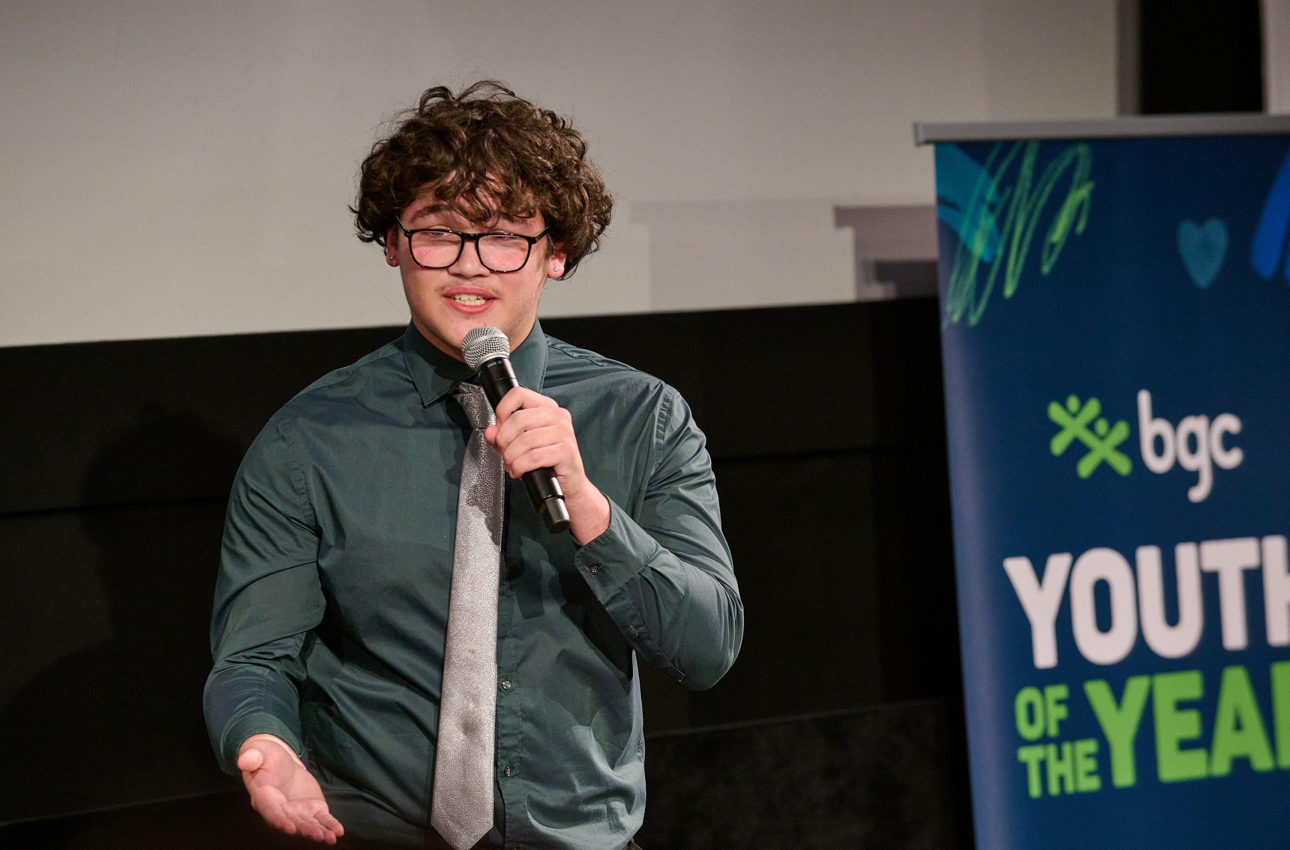 Teenager speaking on a microphone
